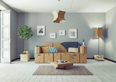 Furniture with cardboard boxes around it in a room